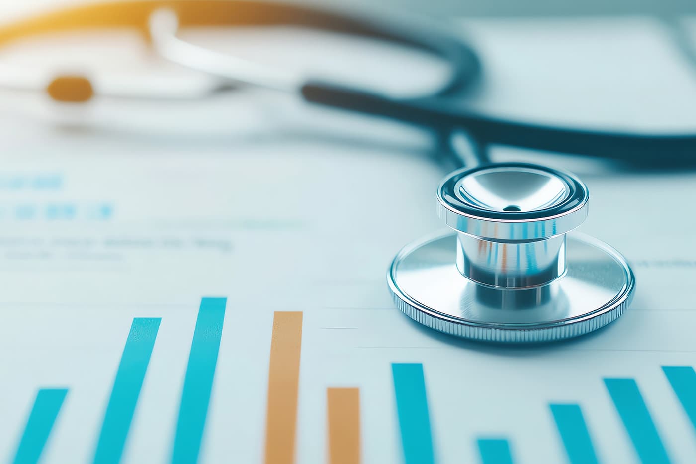 A stethoscope resting on printed bar charts and data reports.